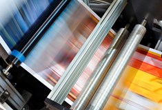 image of blurred coloured paper running through a machine