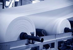 close up of white rolls of material in a factory